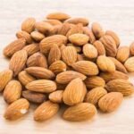 Almond on wooden background